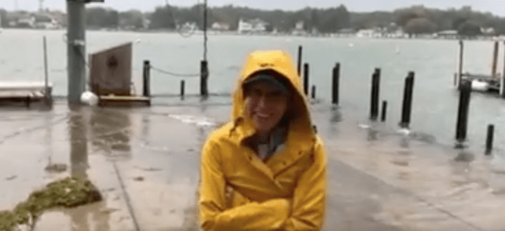Liz Hofreuter stands outside during a storm at Lake Erie to explain to students that when it comes to learning, there is no bad weather.