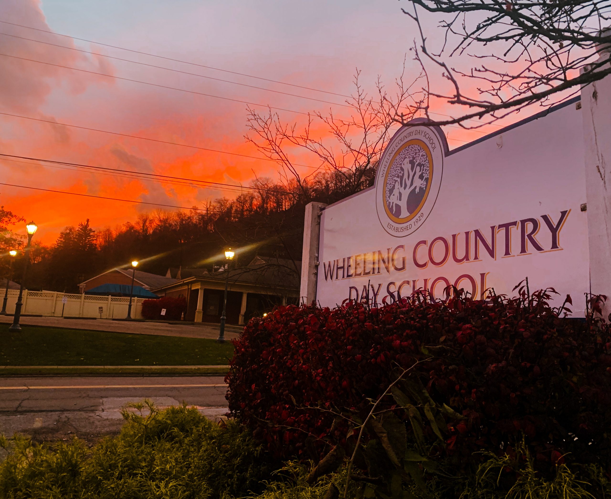 Summer sunset behind the WCDS main campus sign in Wheeling, West Virginia.