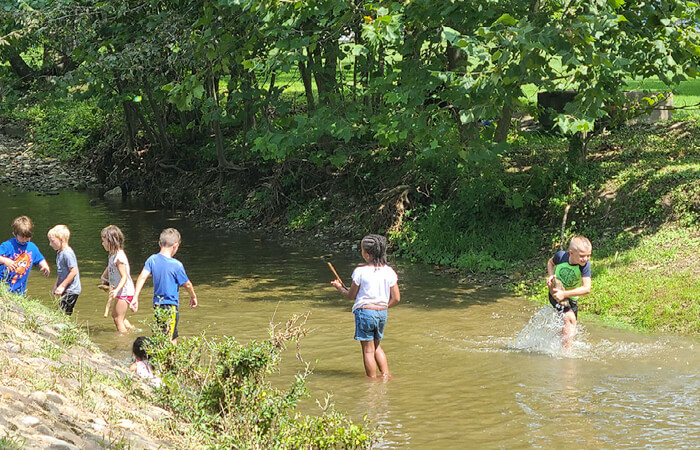 kids playing in creek
