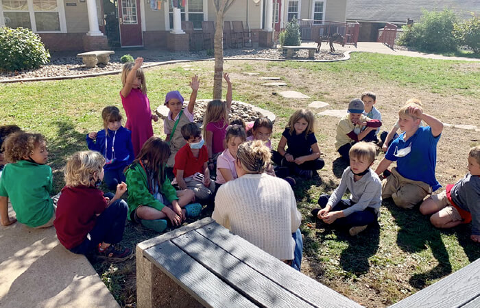 students outside listening to a story